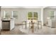 Bright dining area with sleek table, comfortable seating, and natural light from the sliding glass door at 7120 Guess Rd, Hillsborough, NC 27278
