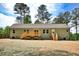 Backyard view of home with wooden deck and newly seeded yard at 7120 Guess Rd, Hillsborough, NC 27278