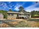 Attractive single-story home featuring light green siding, a white porch, and a gravel front yard at 7120 Guess Rd, Hillsborough, NC 27278