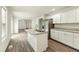 Modern kitchen with stainless steel appliances, gray marble countertops, and an island at 7120 Guess Rd, Hillsborough, NC 27278
