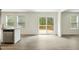 Open kitchen featuring a modern island, stainless steel dishwasher and a sliding glass door to deck at 7120 Guess Rd, Hillsborough, NC 27278