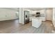 New kitchen with stainless steel appliances, gray marble countertops, and an island at 7120 Guess Rd, Hillsborough, NC 27278