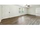 Bright living room featuring modern vinyl floors, a ceiling fan and abundant natural light at 7120 Guess Rd, Hillsborough, NC 27278