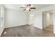 Spacious primary bedroom featuring vinyl floors, ceiling fan, and an ensuite bathroom at 7120 Guess Rd, Hillsborough, NC 27278