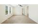 Spacious bedroom with neutral carpet, trim, and walls, bathed in natural light from a large window at 7122 Guess Rd, Hillsborough, NC 27278