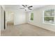 The carpeted bedroom boasts a ceiling fan and two large windows at 7122 Guess Rd, Hillsborough, NC 27278