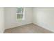 Carpeted bedroom features one window and several electrical outlets at 7122 Guess Rd, Hillsborough, NC 27278