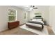 Cozy bedroom with large windows, offering natural light and a calming view of the outdoors at 7122 Guess Rd, Hillsborough, NC 27278