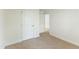 A bright bedroom featuring neutral carpet, trim and walls with doors leading to other rooms at 7122 Guess Rd, Hillsborough, NC 27278