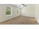 Bright bedroom features neutral carpet, ceiling fan, large windows and plenty of natural light at 7122 Guess Rd, Hillsborough, NC 27278