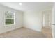 Carpeted bedroom features one large window and a door to the hallway at 7122 Guess Rd, Hillsborough, NC 27278