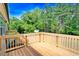 New wooden deck overlooking a spacious backyard with mature trees at 7122 Guess Rd, Hillsborough, NC 27278