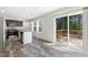 Dining area featuring wood-look flooring, a sliding glass door to the deck, and modern stainless steel appliances at 7122 Guess Rd, Hillsborough, NC 27278
