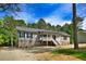 Charming single-story home with gray siding, stone foundation, and a welcoming front porch at 7122 Guess Rd, Hillsborough, NC 27278