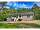 Charming single-story home with gray siding, stone foundation, and a welcoming front porch at 7122 Guess Rd, Hillsborough, NC 27278