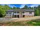 Charming single-story home with gray siding, stone foundation, and a welcoming front porch at 7122 Guess Rd, Hillsborough, NC 27278