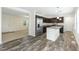 Stylish kitchen showcasing wood-look flooring, stainless steel appliances, and an island at 7122 Guess Rd, Hillsborough, NC 27278