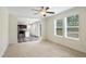 Inviting living room showcasing an open-concept design with an adjacent kitchen and large windows at 7122 Guess Rd, Hillsborough, NC 27278