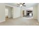 Spacious living room with neutral carpeting, offering access to a bathroom and kitchen at 7122 Guess Rd, Hillsborough, NC 27278