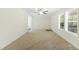 Bright living room features neutral carpet, ceiling fan, large windows and plenty of natural light at 7122 Guess Rd, Hillsborough, NC 27278