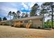 Rear view of home featuring a wooden deck, gray siding, and stone foundation at 7122 Guess Rd, Hillsborough, NC 27278