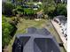 Aerial view of a well-maintained lawn, featuring a gray roof and lush trees at 721 Shelley Rd, Raleigh, NC 27609