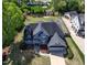 An aerial view of a blue house, showing its roof, landscaping, and surrounding neighborhood at 721 Shelley Rd, Raleigh, NC 27609