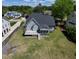 Drone view of a house and backyard featuring a deck and lush lawn at 721 Shelley Rd, Raleigh, NC 27609