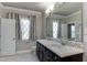 Bright bathroom featuring double sinks with modern faucets, decorative mirror, and natural light from the window at 721 Shelley Rd, Raleigh, NC 27609