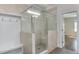 Elegant bathroom featuring a glass-enclosed shower with a built-in seat and tiled walls at 721 Shelley Rd, Raleigh, NC 27609