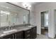 Luxurious bathroom with dual sinks, granite counters, and a glass-enclosed shower at 721 Shelley Rd, Raleigh, NC 27609