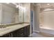 Bathroom featuring double sinks and a shower-tub combination with white tile at 721 Shelley Rd, Raleigh, NC 27609