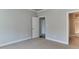 A simple bedroom with neutral walls and carpet, connecting to the bathroom with a tub at 721 Shelley Rd, Raleigh, NC 27609