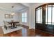 Bright dining room featuring wood floors, white wainscoting, and a modern light fixture at 721 Shelley Rd, Raleigh, NC 27609
