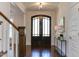Elegant foyer featuring hardwood floors, a decorative front door, and stylish decor at 721 Shelley Rd, Raleigh, NC 27609