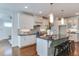 Bright kitchen features white cabinets, granite countertops, and a functional center island with seating at 721 Shelley Rd, Raleigh, NC 27609