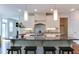 Modern kitchen boasts granite counters, an island with seating, and stainless steel appliances at 721 Shelley Rd, Raleigh, NC 27609