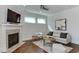 Cozy living room featuring a fireplace, recessed lighting, and neutral decor creating a comfortable space at 721 Shelley Rd, Raleigh, NC 27609