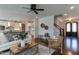 Cozy living room featuring hardwood floors, white sofa, ceiling fan, and an open layout to the kitchen at 721 Shelley Rd, Raleigh, NC 27609