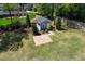 Aerial view of backyard outbuilding with a welcoming yellow door and patio at 721 Shelley Rd, Raleigh, NC 27609