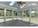 Sunroom with many windows offering natural light, ceiling fan, and views of the backyard at 721 Shelley Rd, Raleigh, NC 27609