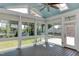Sunroom with many windows offering natural light, ceiling fan, and views of the backyard at 721 Shelley Rd, Raleigh, NC 27609