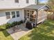 Backyard featuring a screened-in porch, outdoor seating area, and well-maintained lawn at 802 Knollwood Dr, Apex, NC 27502