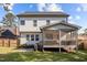 Lush backyard featuring a screened-in porch and patio with outdoor seating and a grill at 802 Knollwood Dr, Apex, NC 27502