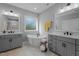 Elegant bathroom features dual vanities, modern tub, and tile floors for spa-like experience at 802 Knollwood Dr, Apex, NC 27502