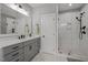 Bright bathroom features a large vanity, mirror and tiled shower for a luxurious feel at 802 Knollwood Dr, Apex, NC 27502