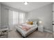 Bright bedroom with plush carpet, a well-decorated bed, and sheer curtains allowing natural light at 802 Knollwood Dr, Apex, NC 27502
