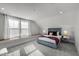 Cozy bedroom with plush bedding, a padded headboard, and large windows at 802 Knollwood Dr, Apex, NC 27502