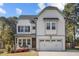 Charming two-story home featuring white board and batten siding and a two-car garage at 802 Knollwood Dr, Apex, NC 27502