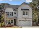 Beautiful new home with white siding, a covered porch, and an attached two-car garage at 802 Knollwood Dr, Apex, NC 27502